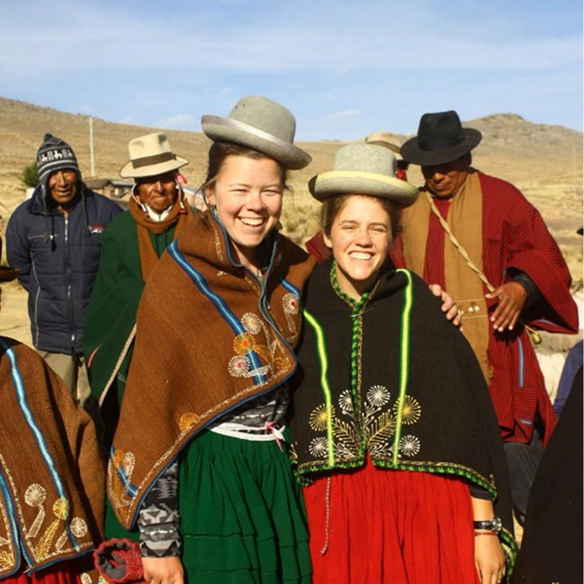Claire Majors and Cat Feistner wearing hats and clothes from Carani, Bolivia
