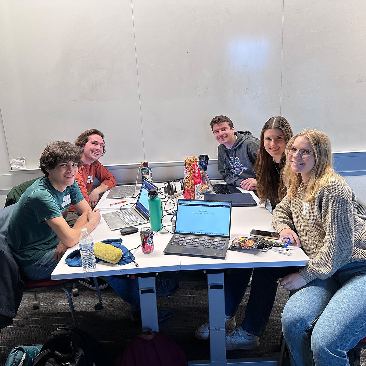 Megan Nulf and 4 other Uidaho engineering students s at a study table.
