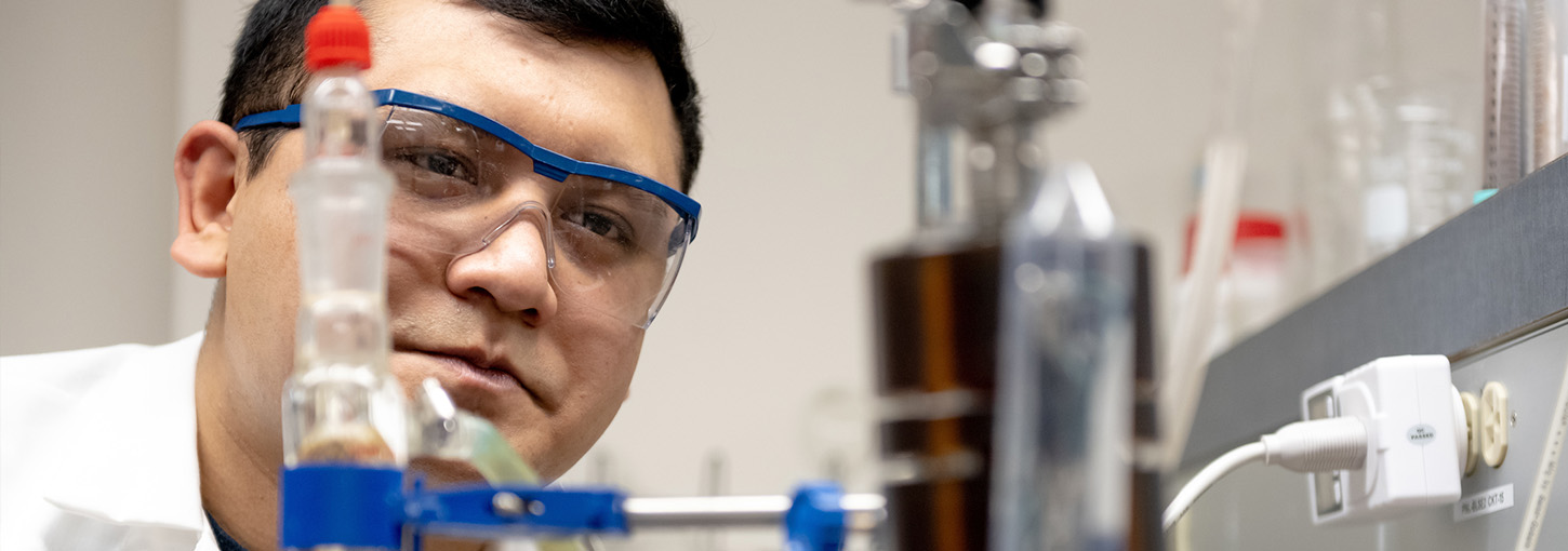 Bishal Thapa monitors a plasma reactor used in developing a greener fertilizer production process. 