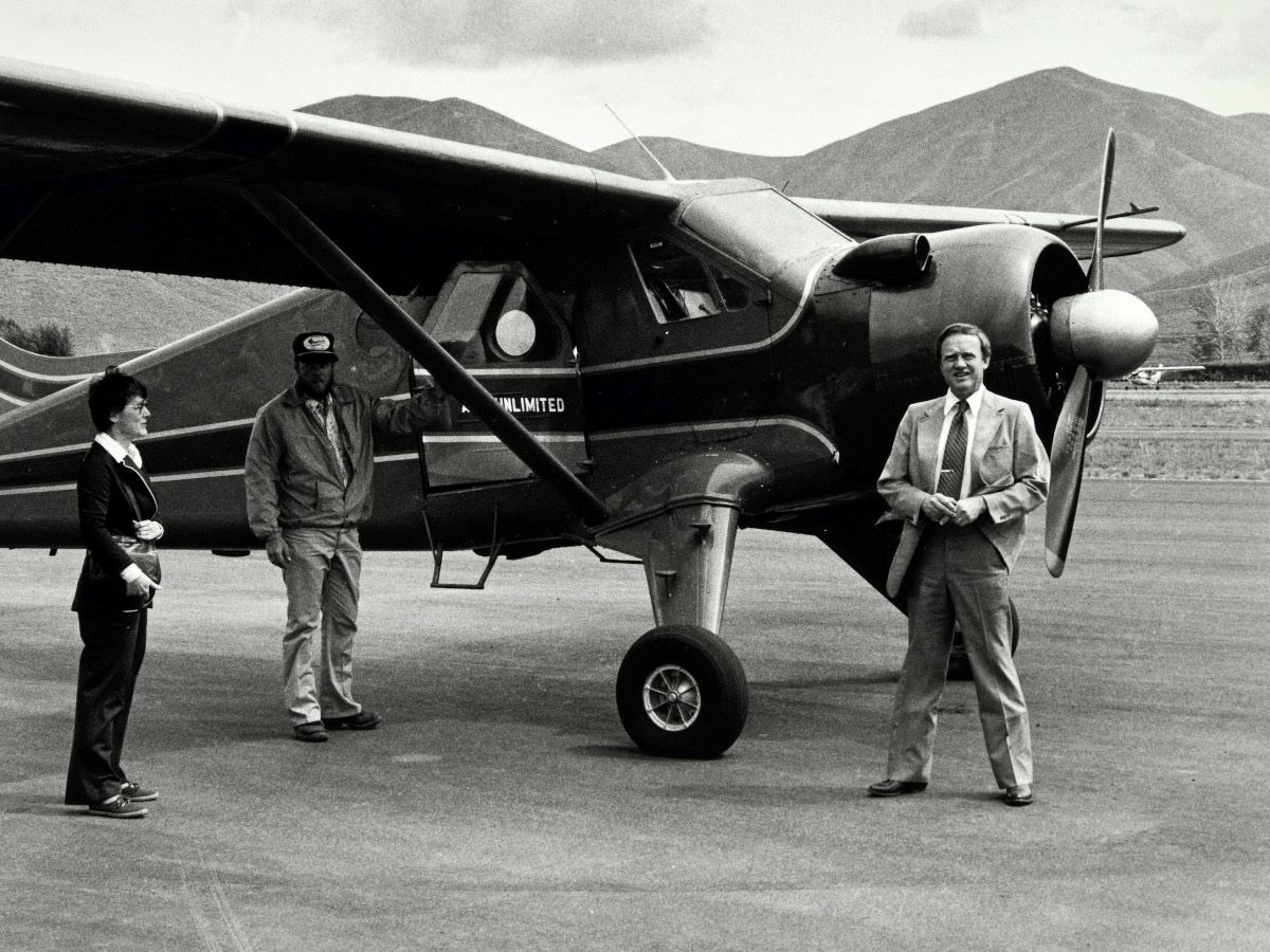 Jim and Louise McClure with another person standing in front of a small plane