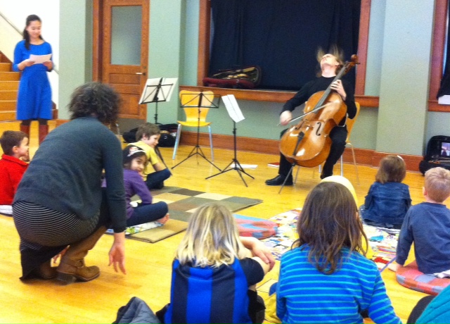 Children listen to the Chiara String Quartet at the ACMS Rug Concert.