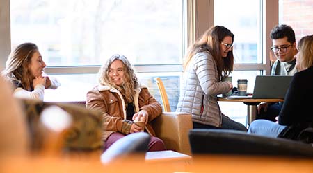 Students sharing coffee at Einstein Bros on campus