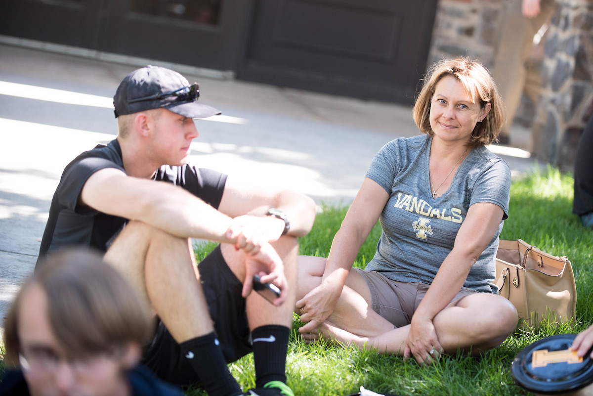 mom and son sitting on grass