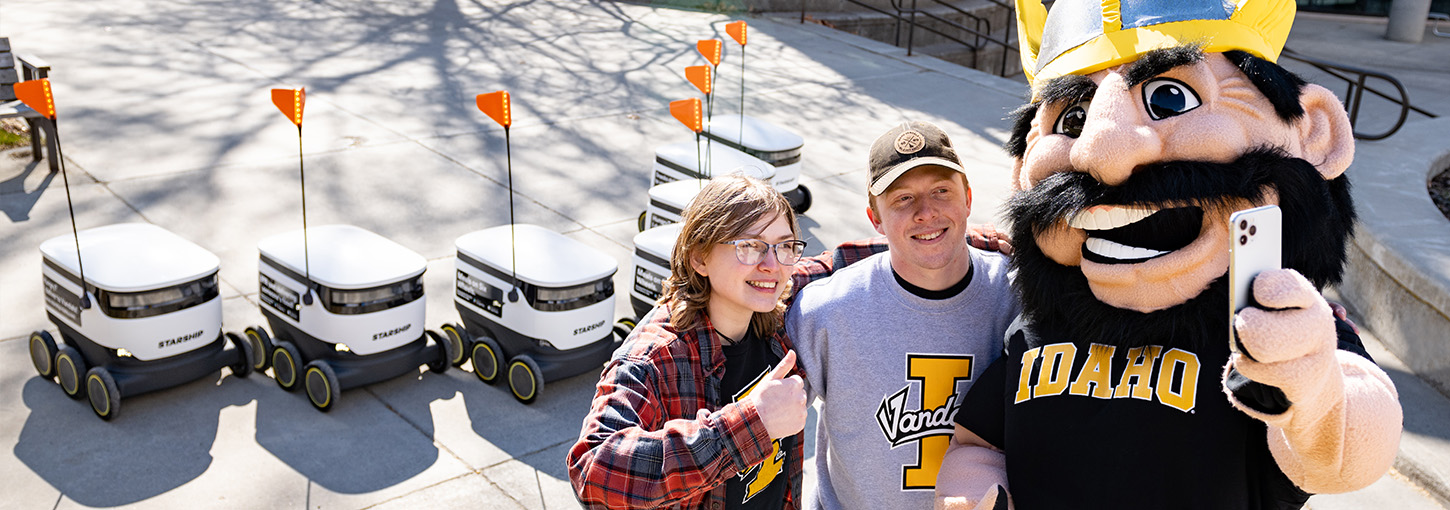 Joe Vandal taking a selfie in front of the starship food delivery robots