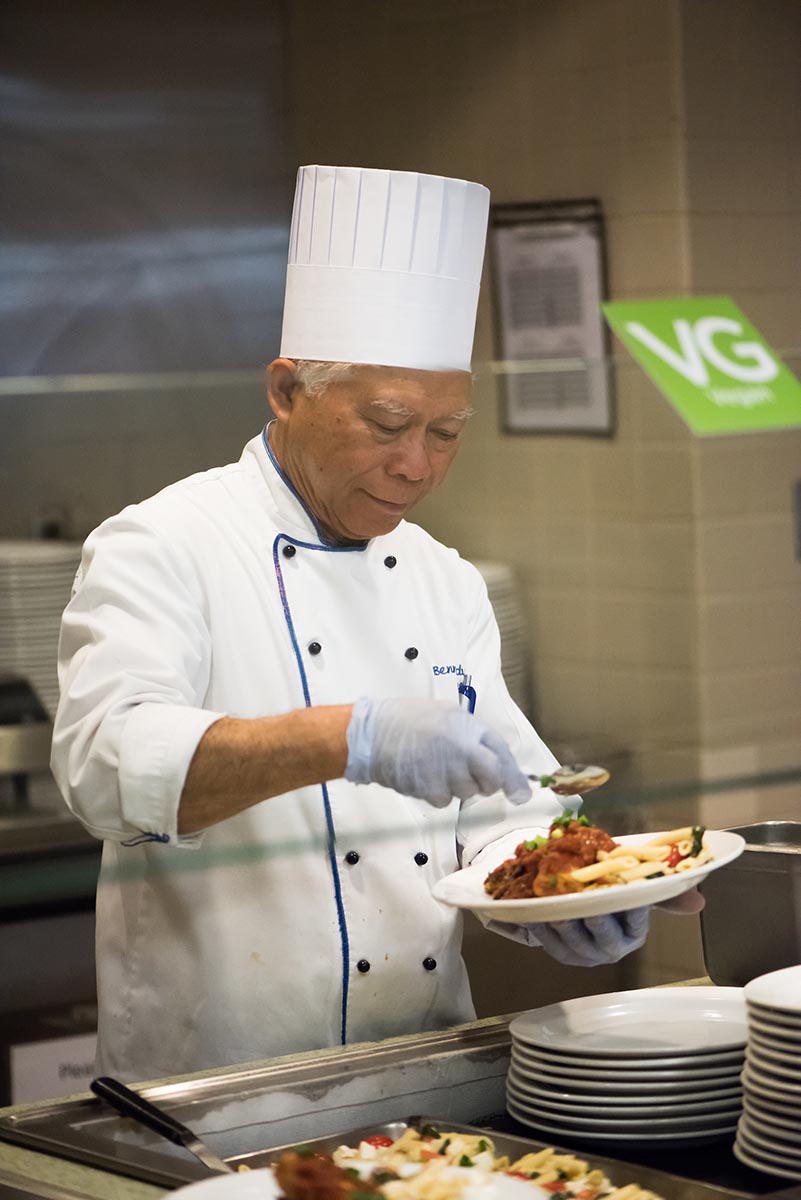 A chef prepares a plate at the Hub dining hall