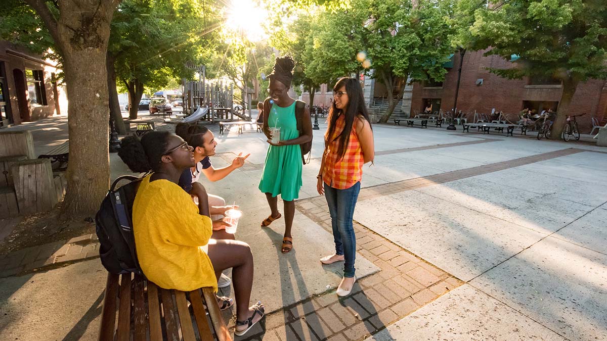 Students in Friendship Square on a summer evening