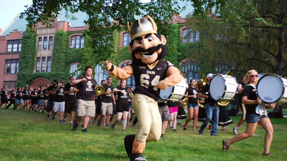 Joe Vandal marches through the Administration Building Lawn with the Vandal Marching band