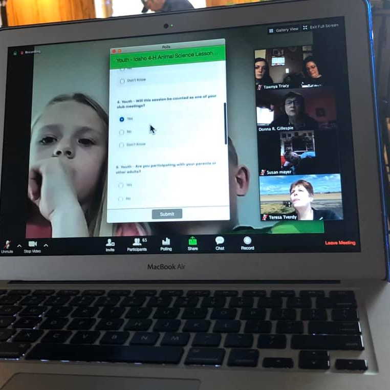 A computer screen shows children thinking about multiple choice questions.