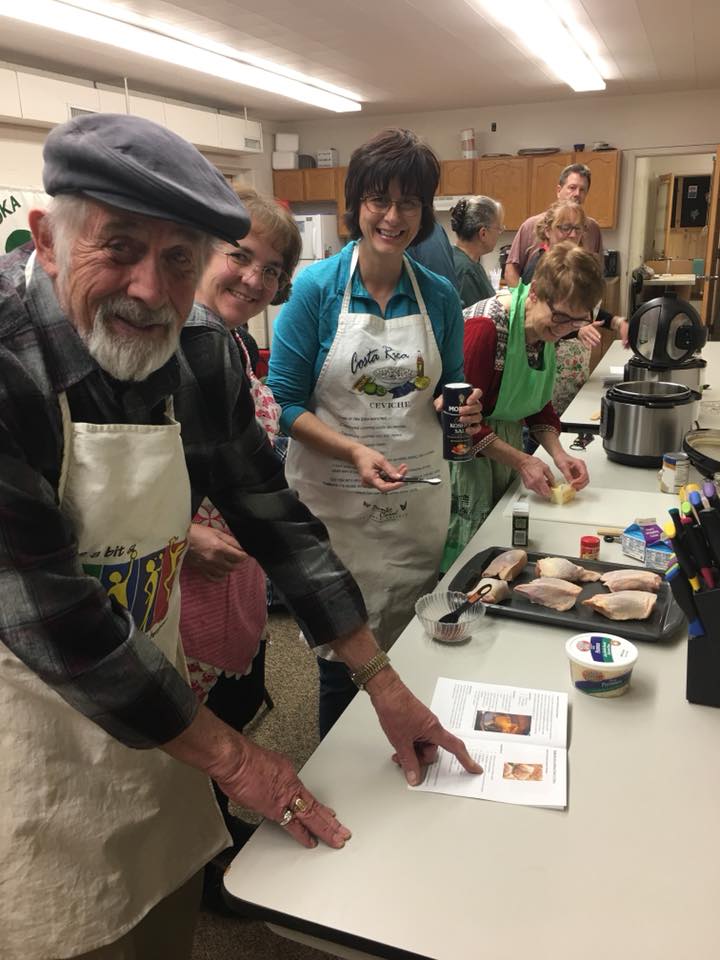Participants follow a recipe in cooking class. 