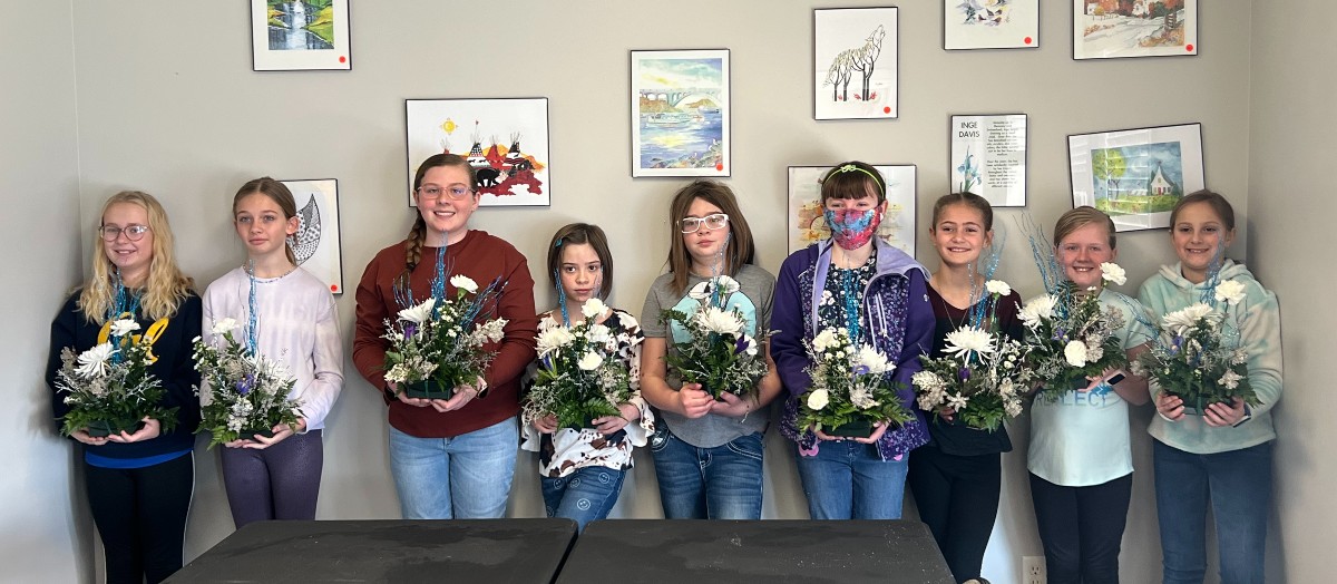 4-H youth showing floral arrangements they made