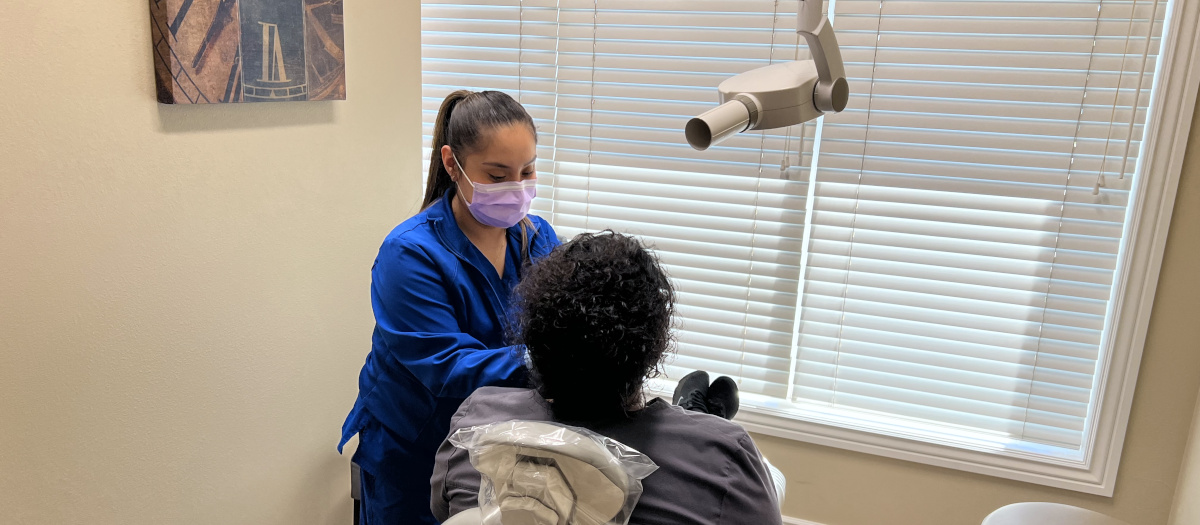 Angelica Gomez takes dental films of a patient.