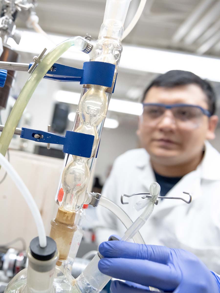Bishal Thapa monitors a plasma reactor used in developing a greener fertilizer production process.