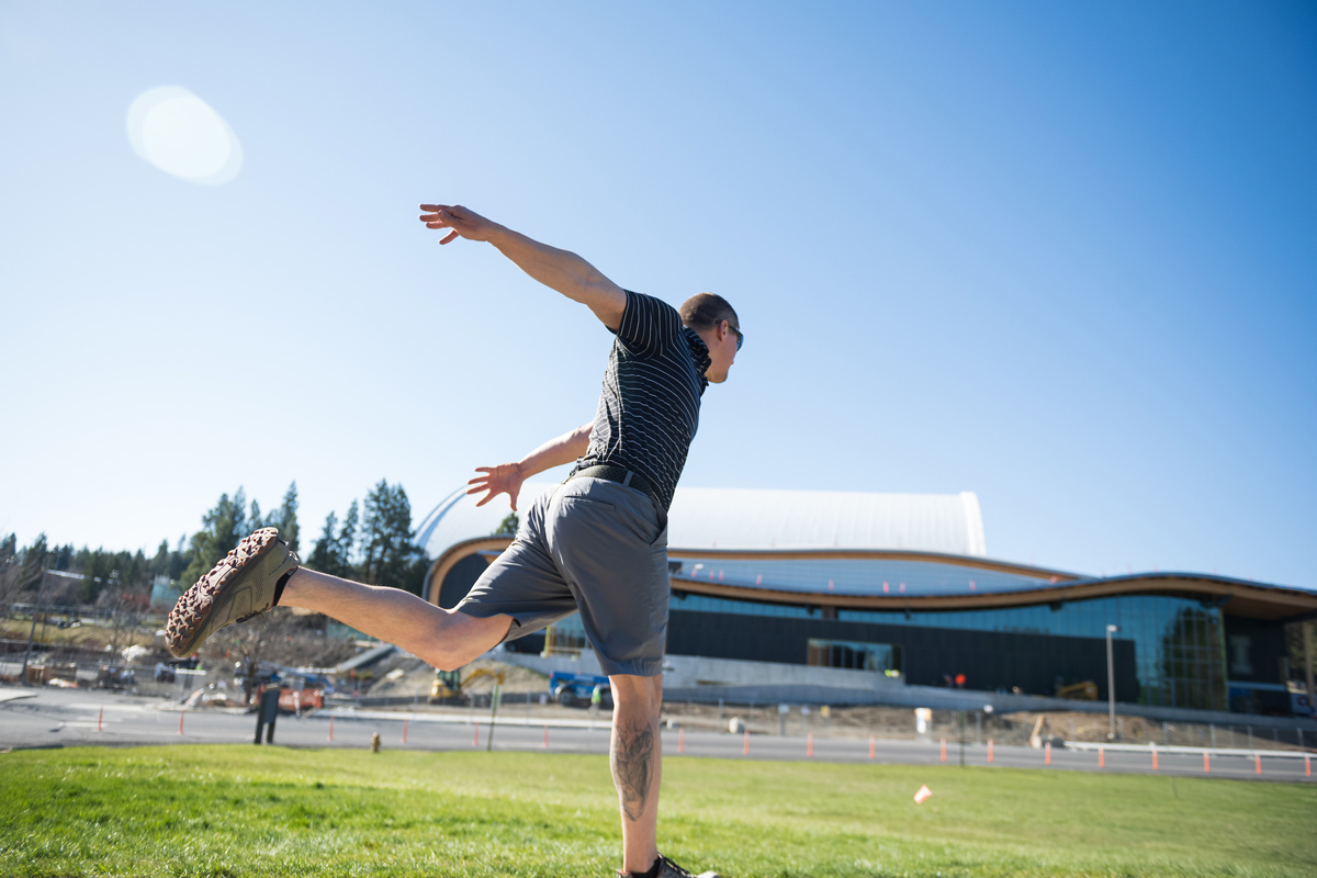 Trevor Pumnea throws a disc off the tee on the Moscow campus course.