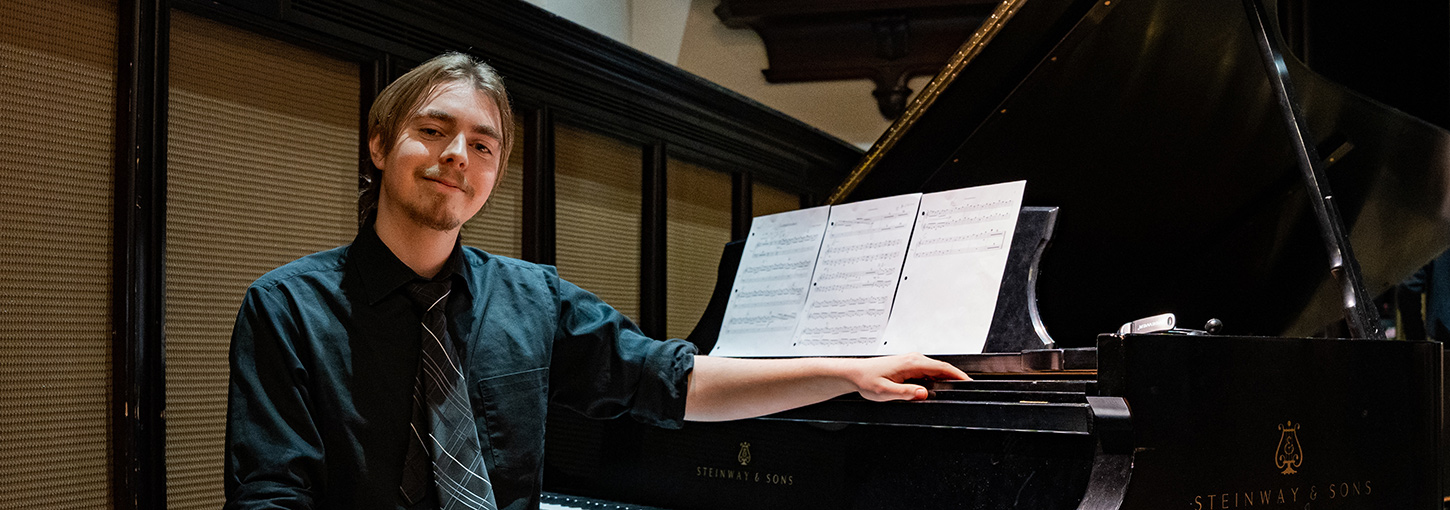Spencer Cuppage sits at the piano