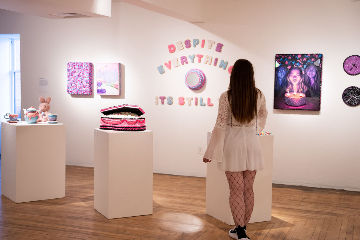 Back view of woman looking at her art display