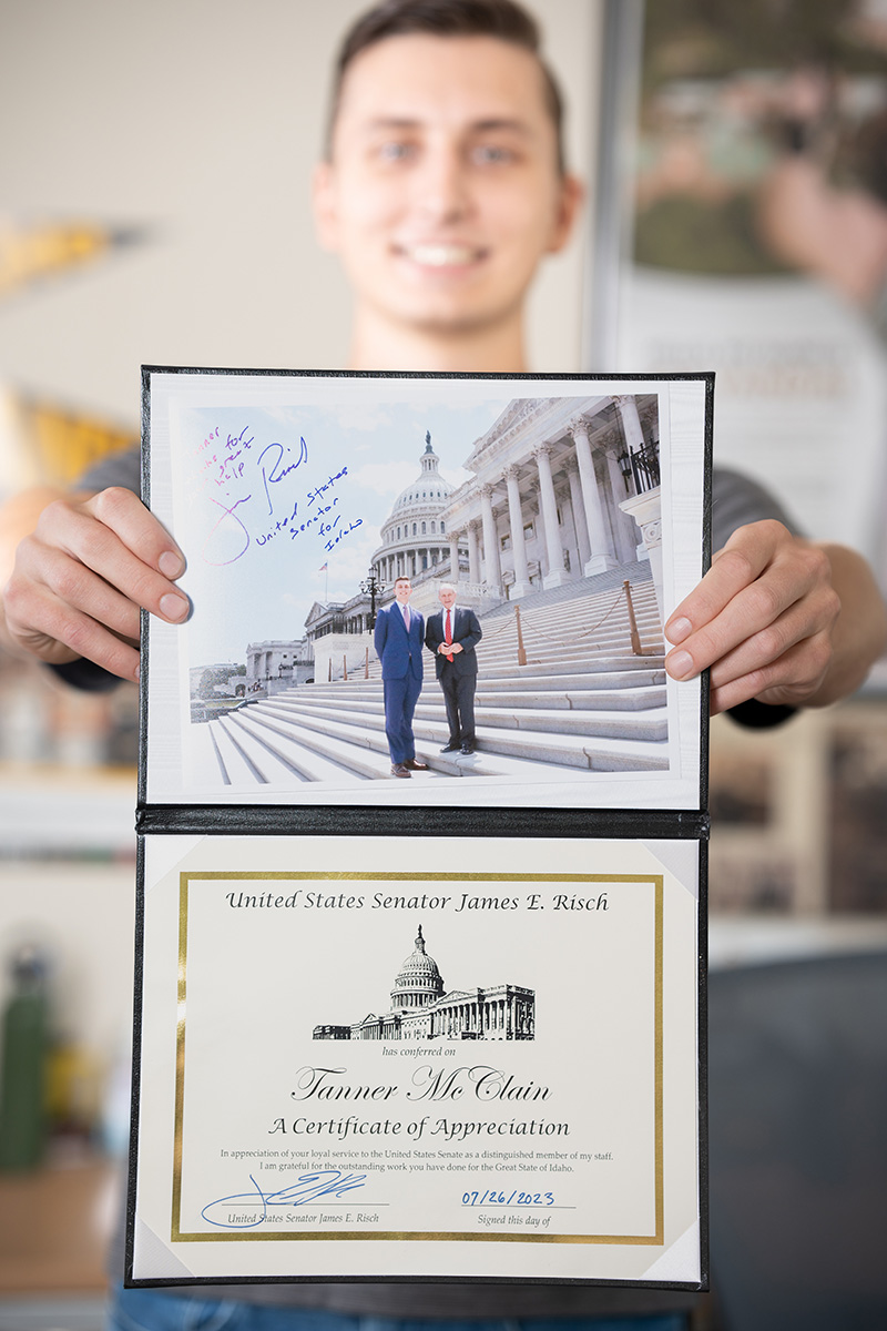 Student holds Congressional plaque.