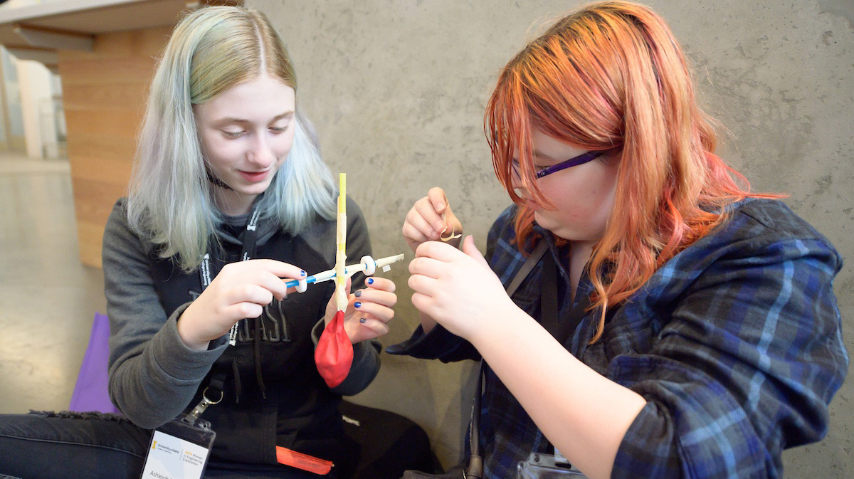 Two engineering students work with materials.