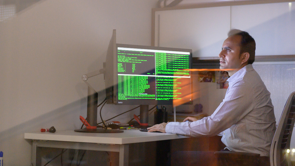 Researcher examining data on computer screen