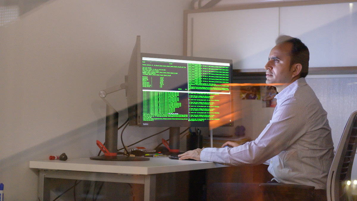 Researcher examining data on computer screen