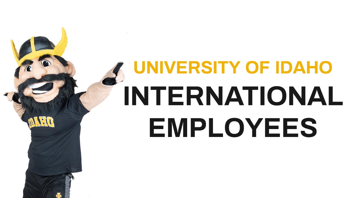 Joe Vandal pointing to gold and black text: University of Idaho International Employees