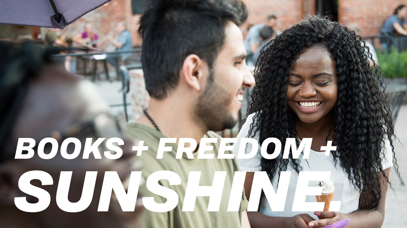 Two students laughing. Text: Books + Freedom + Sunshine