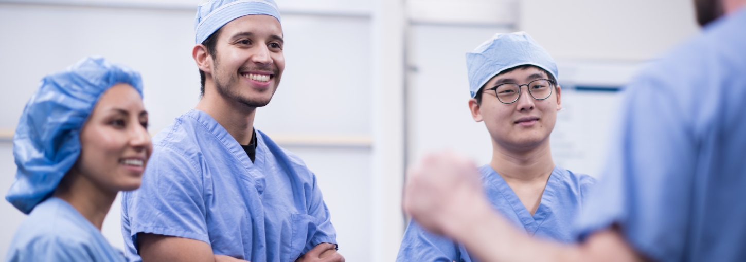 Medical students in blue scrubs
