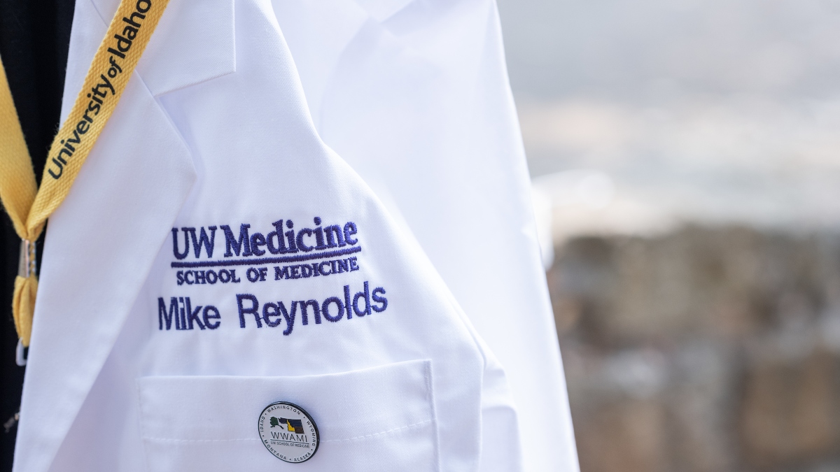A close-up of Mike Reynolds’ name on his white coat.