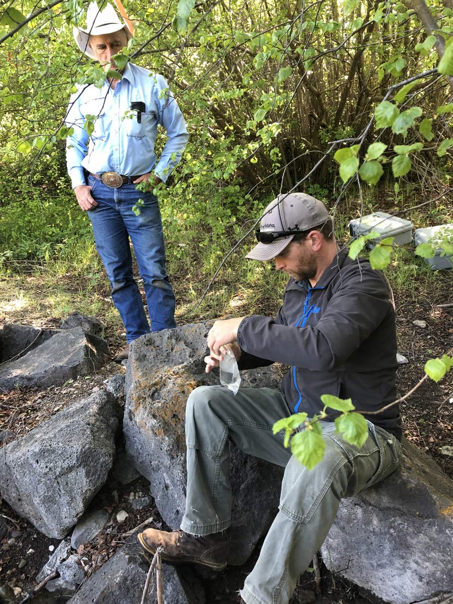 Eric Winford, with the Rangeland Center collects water samples in Mink Creek.