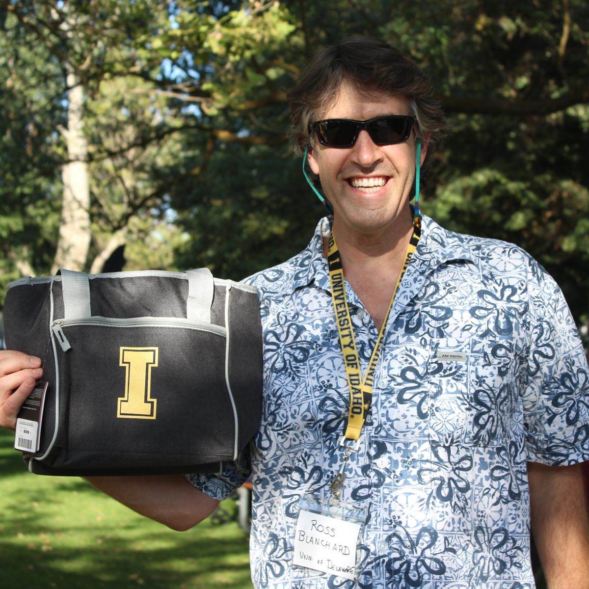 Law student Steven Blanchard poses with his prize, a totebag.