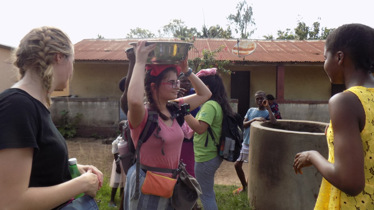 Trinity Dion practiced carrying a bucket of water on her head.