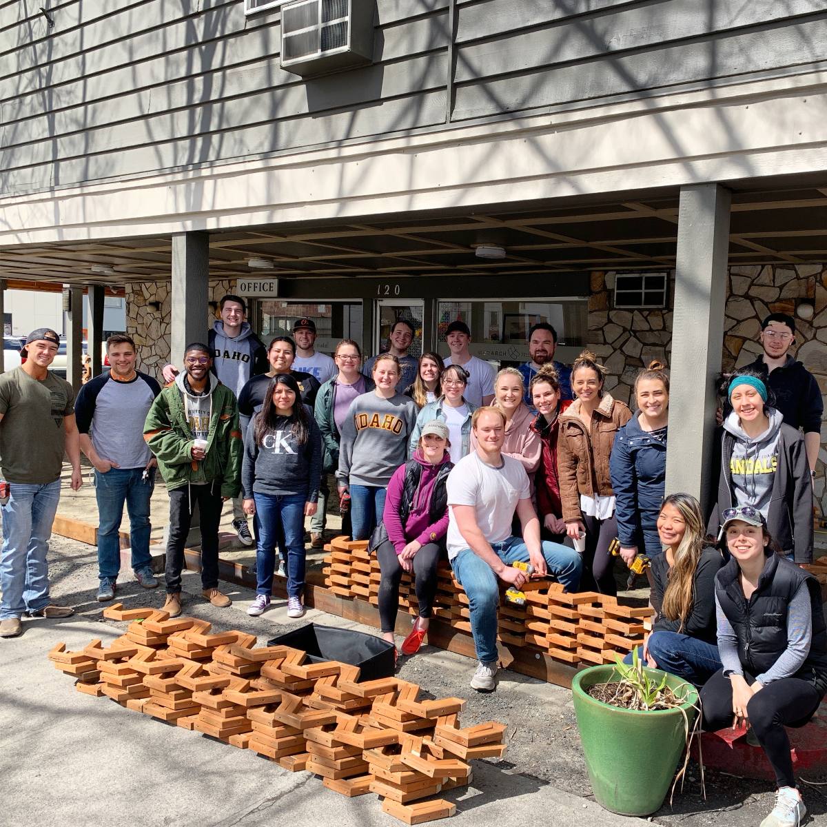 Design-Build students pose for a photo in front of the completed Monarch Motel patio.