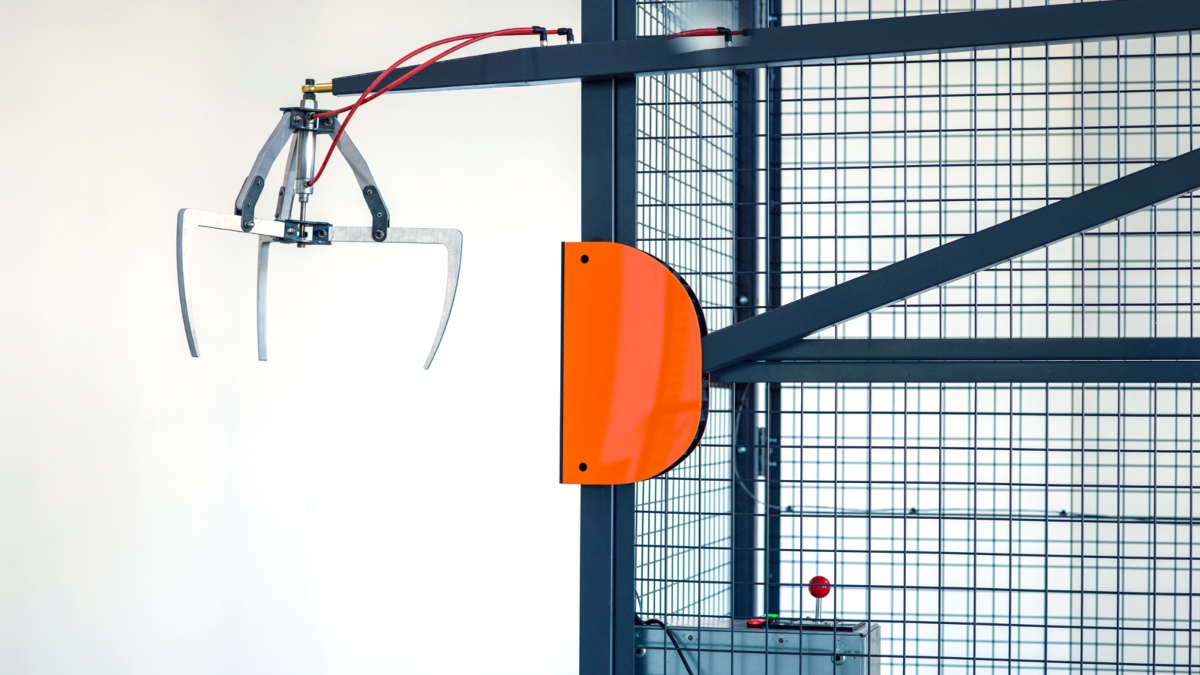 A mechanical arm extends from a rack.