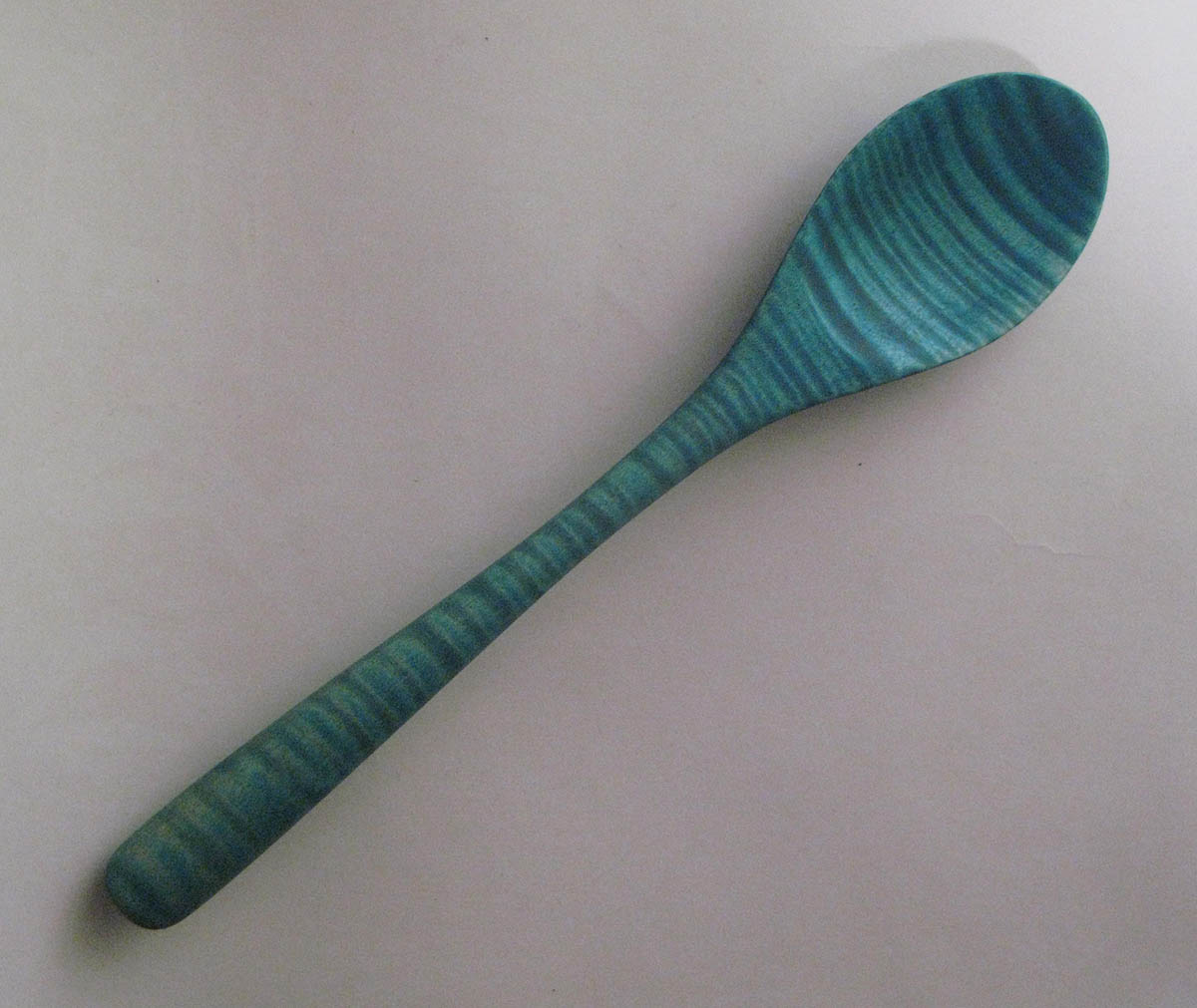 Blue wooden spoon by Ted Kelchner.