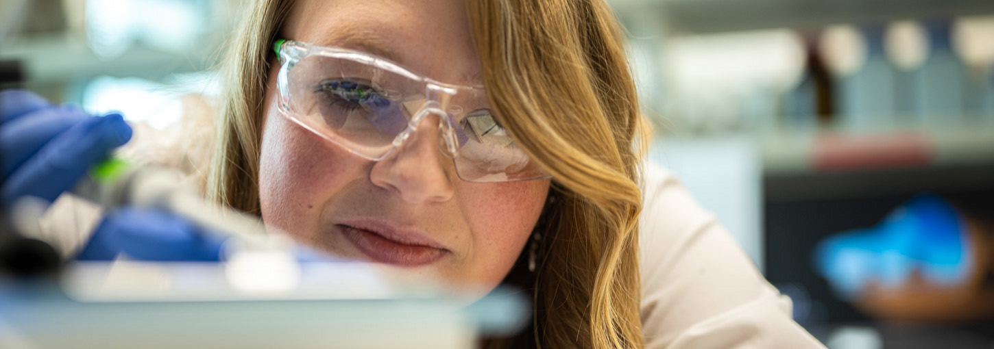 Woman using a pipette.