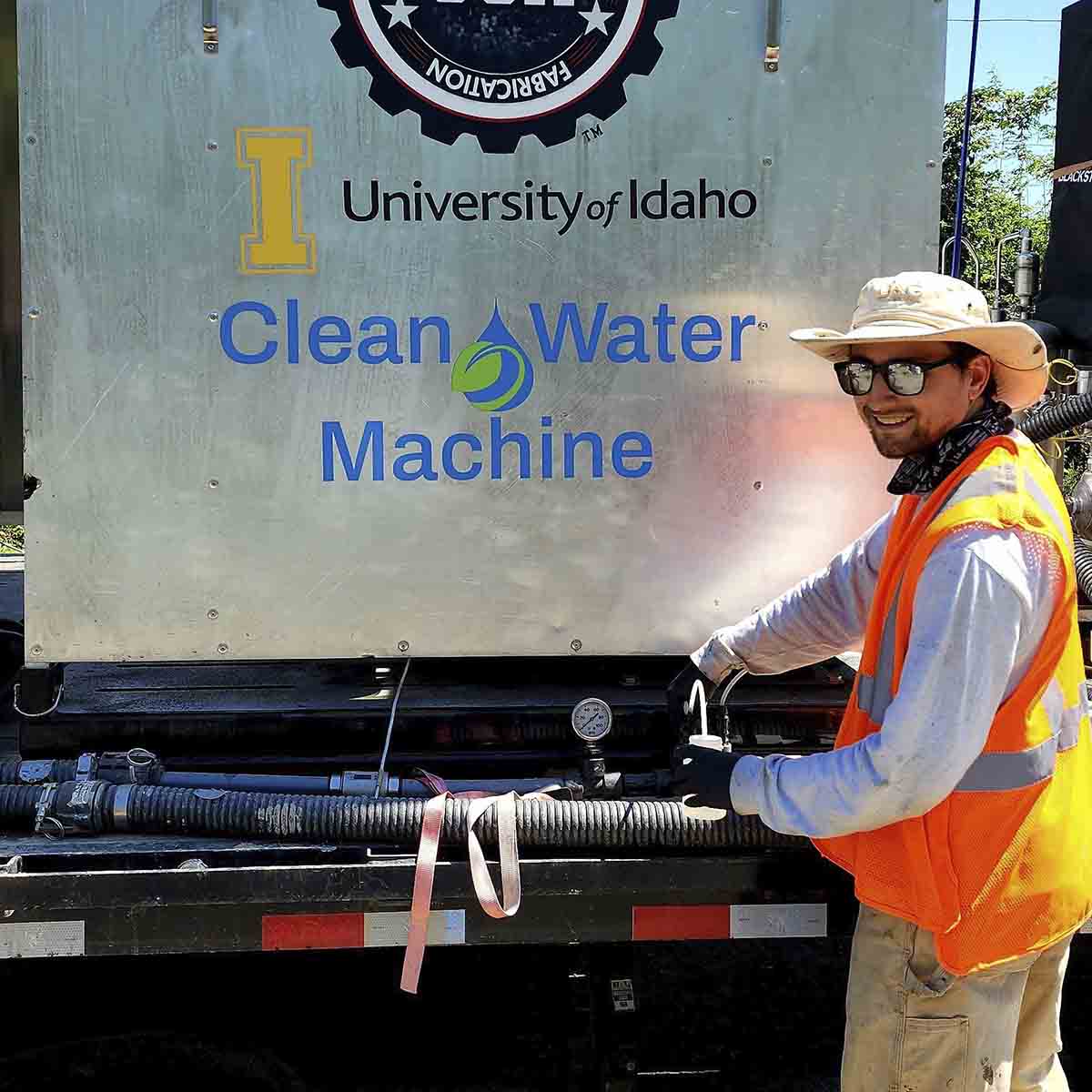 A man makes adjustments to the Clean Water Machine.