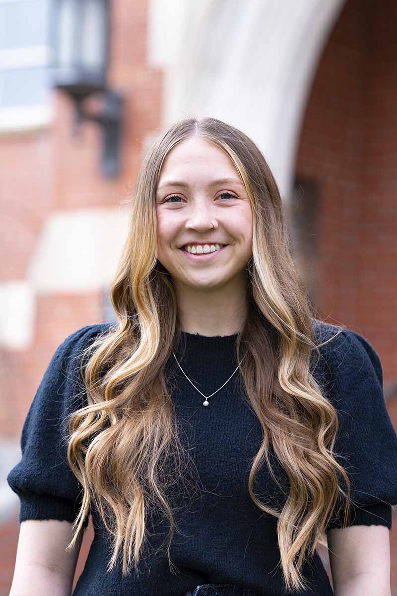 A portrait of a woman outside a building on the University of Idaho campus.