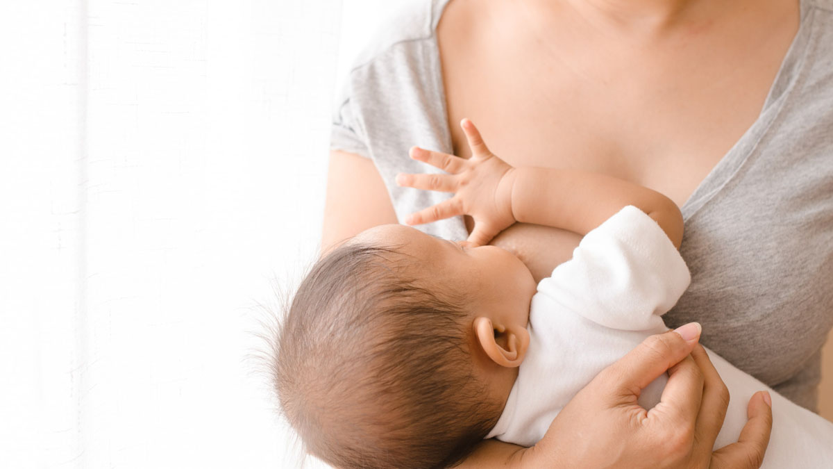 A woman breast feeding infant