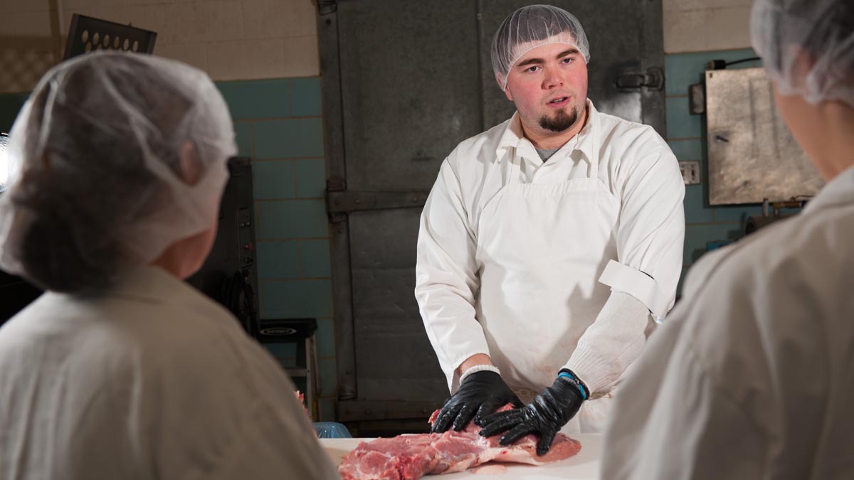 James Nasados teaching students about the cut of meat.