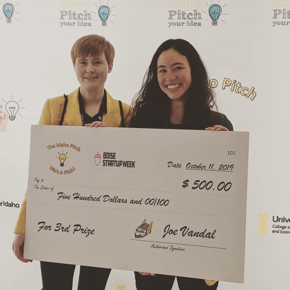 Morgan Morrisroe and Maggie Zee hold an oversized check for $500 from the Idaho Pitch.