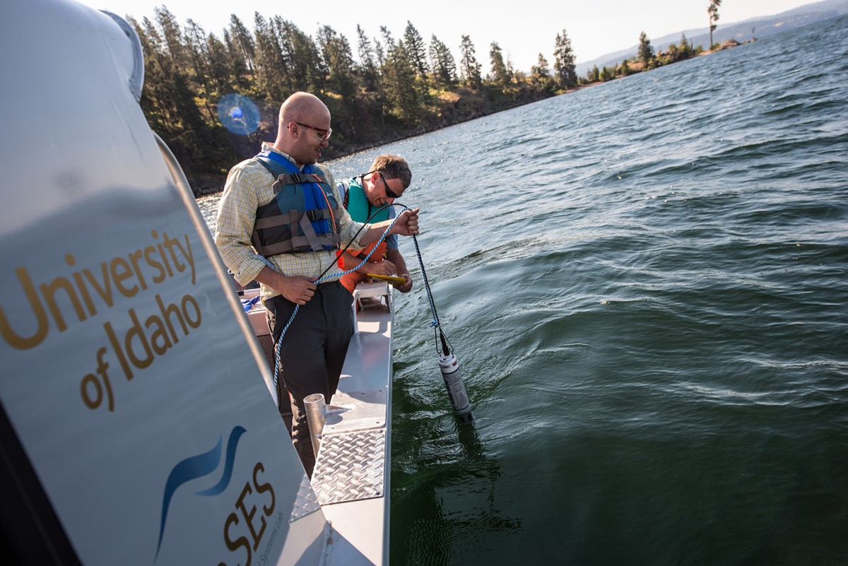 Researchers on a boat lower a probe into Coeur d'Alene lake