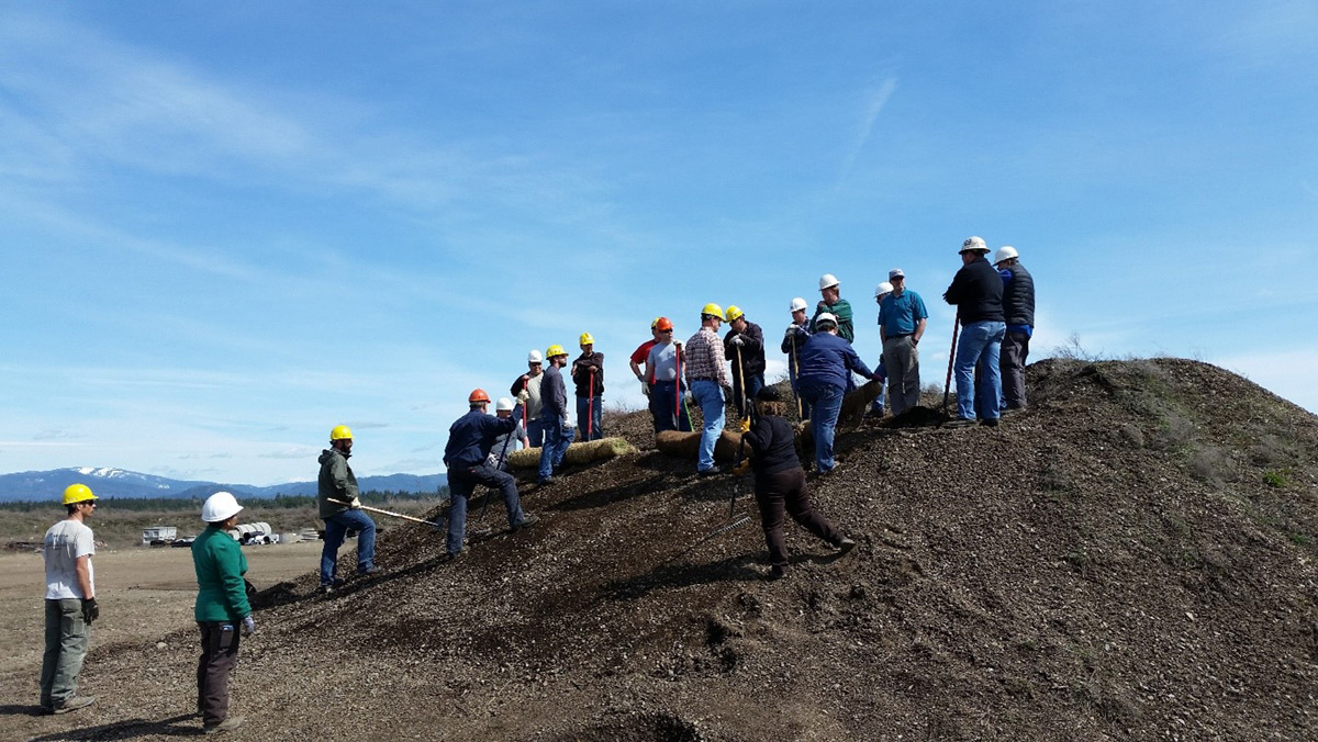 A SEEP class stands atop a dirt hill.