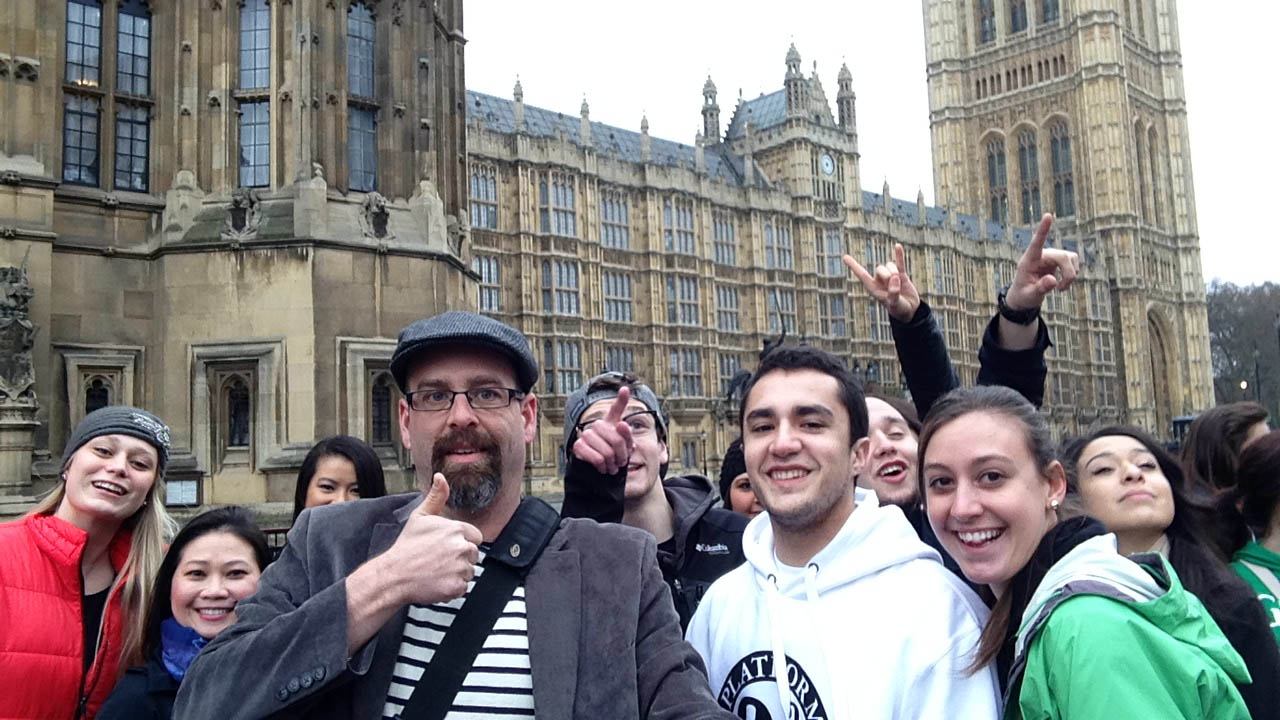 Brian Wolf and a group of students posing in front of Parliament.