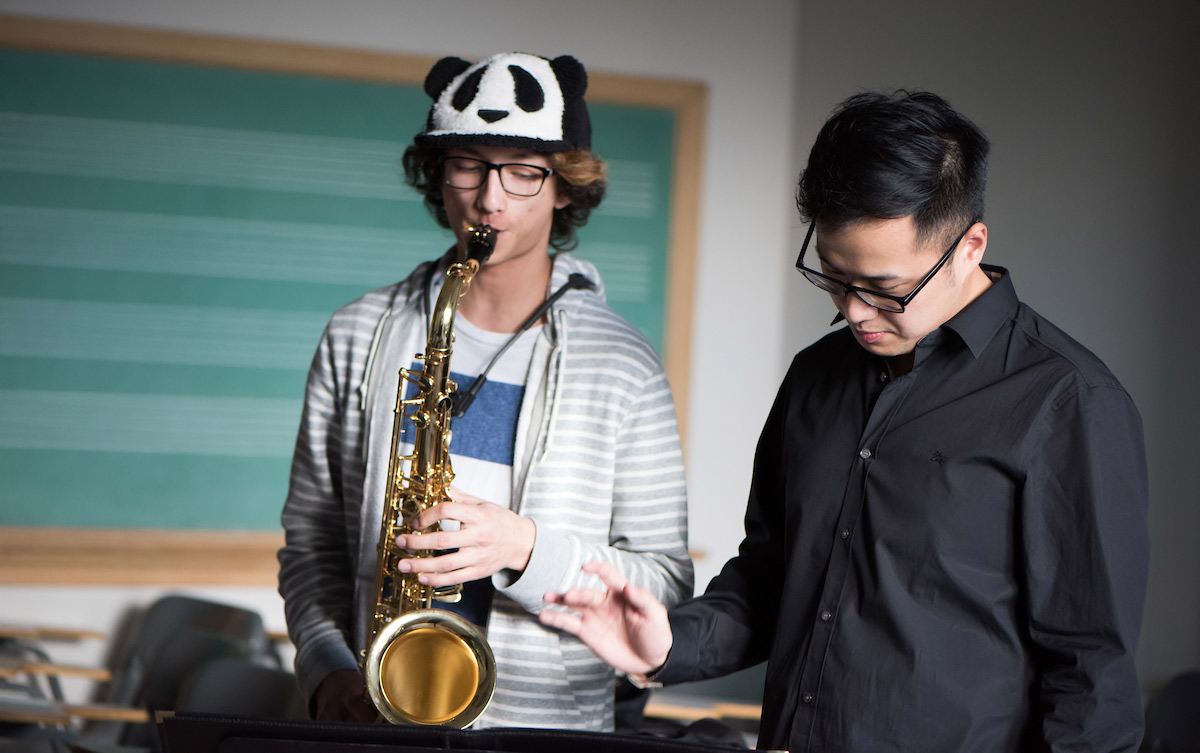 Lu teaching a student during a saxophone studio class.