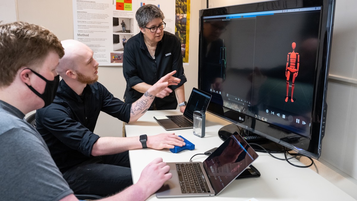 Students review results of study with their professor. 