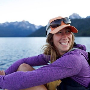 Beth Kochevar, K12 Program Development Coordinator sits by the lake