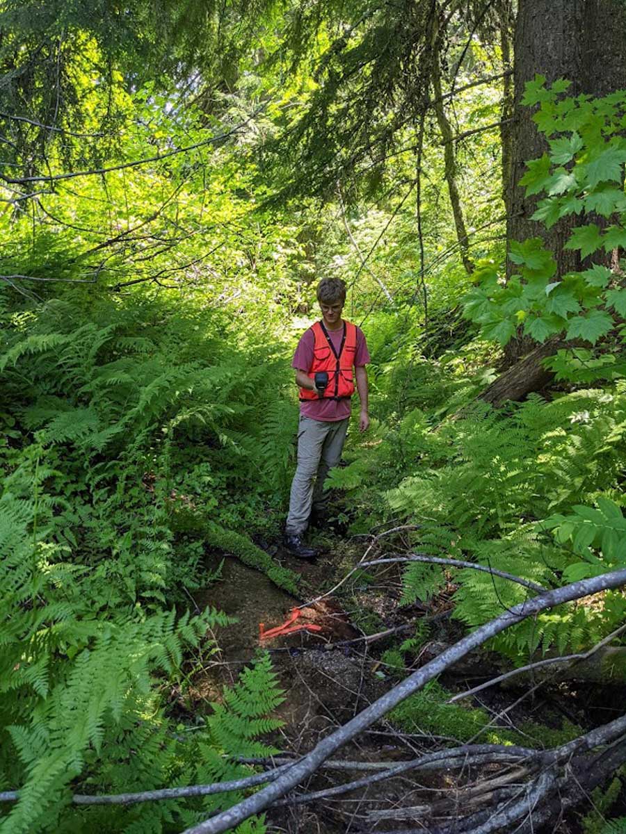 Clayton Christensen conducts a stream temperature survey with a dual infrared and visible imaging camera as part of the Washington Department of Natural Resources project.