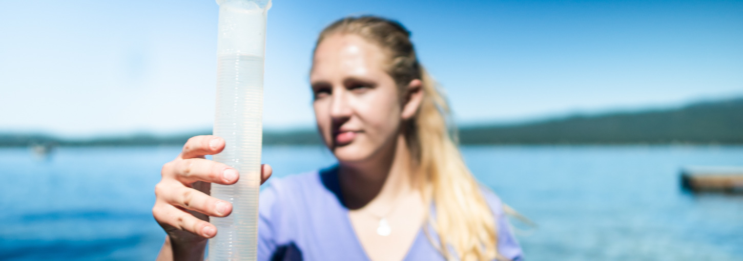 Heather Crawford holds up a water sample.