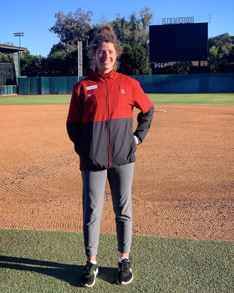 Woman standing in middle of softball field