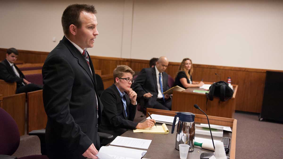 College of Law student in a courtroom during a mock trial.