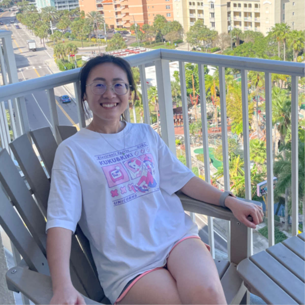 Xia Liu sitting on a balcony